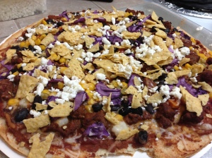 refried beans, taco sauce, corn, hominy, black beans, shredded cheese, taco seasoned ground beef, red cabbage (thank you clarisa!!), feta, and tortilla chips